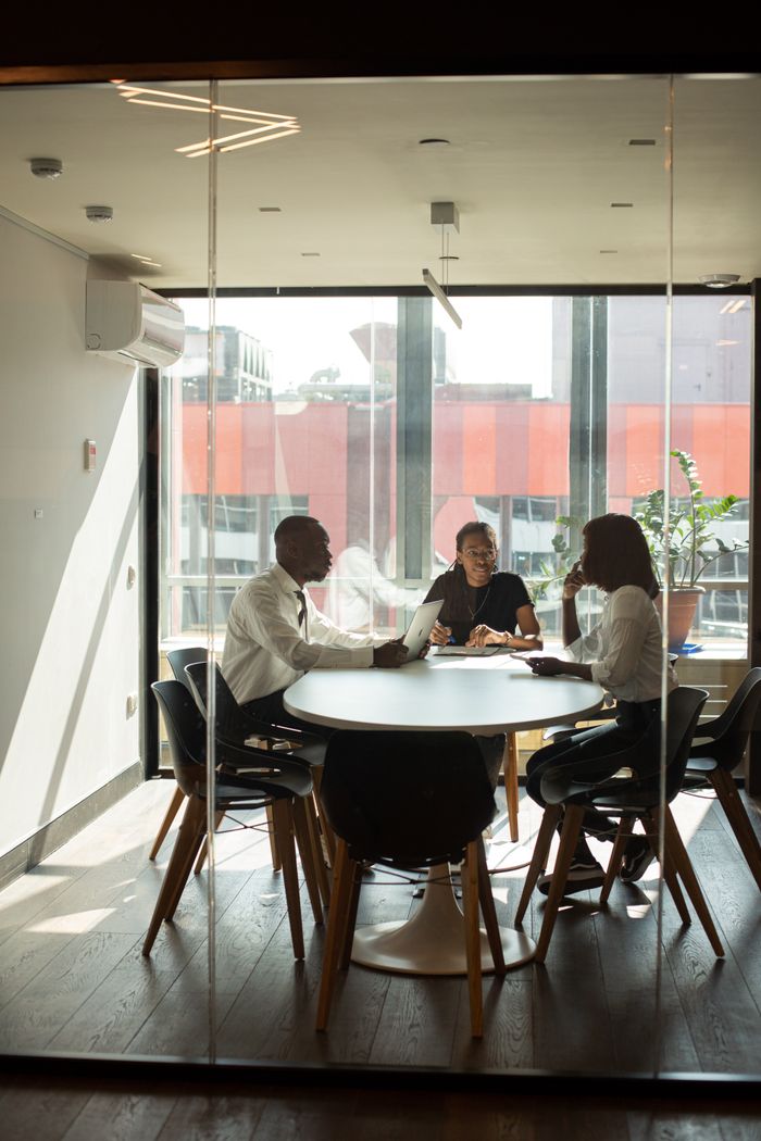 gallery-3 Business professionals in a modern office meeting room collaborating on projects.